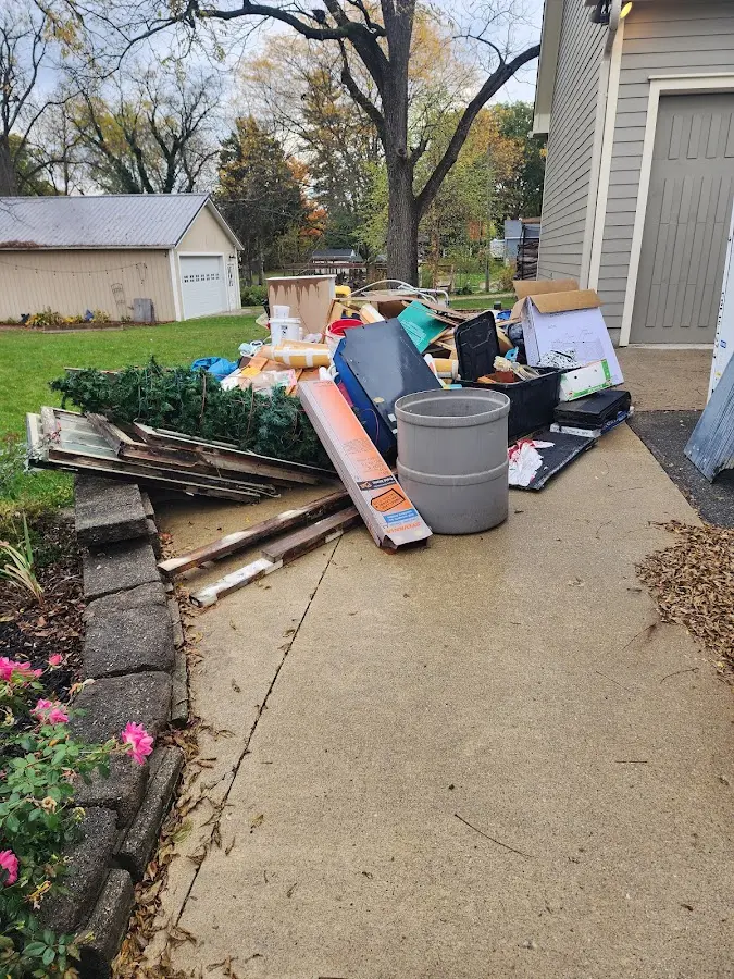 Dumpster being loaded with debris for Estate Cleanout Dumpster Rental in Ewing